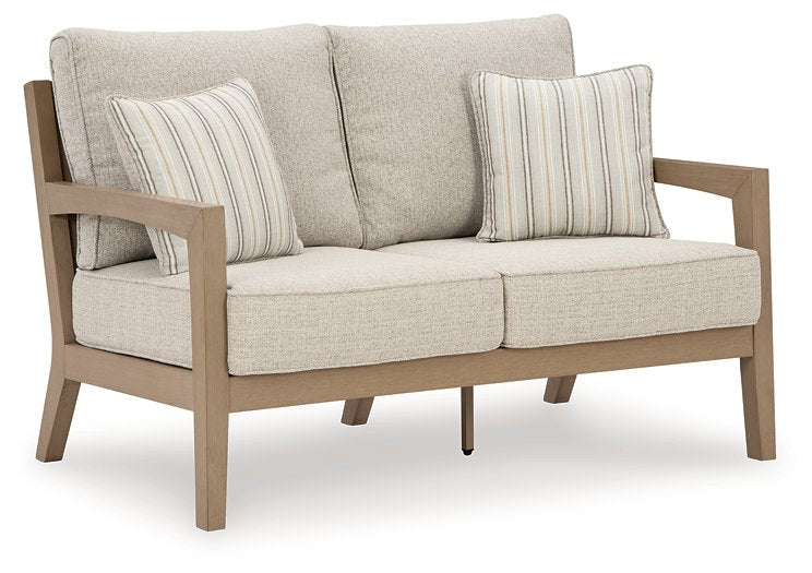 Hallow Creek Outdoor Loveseat with Cushion Half Price Furniture