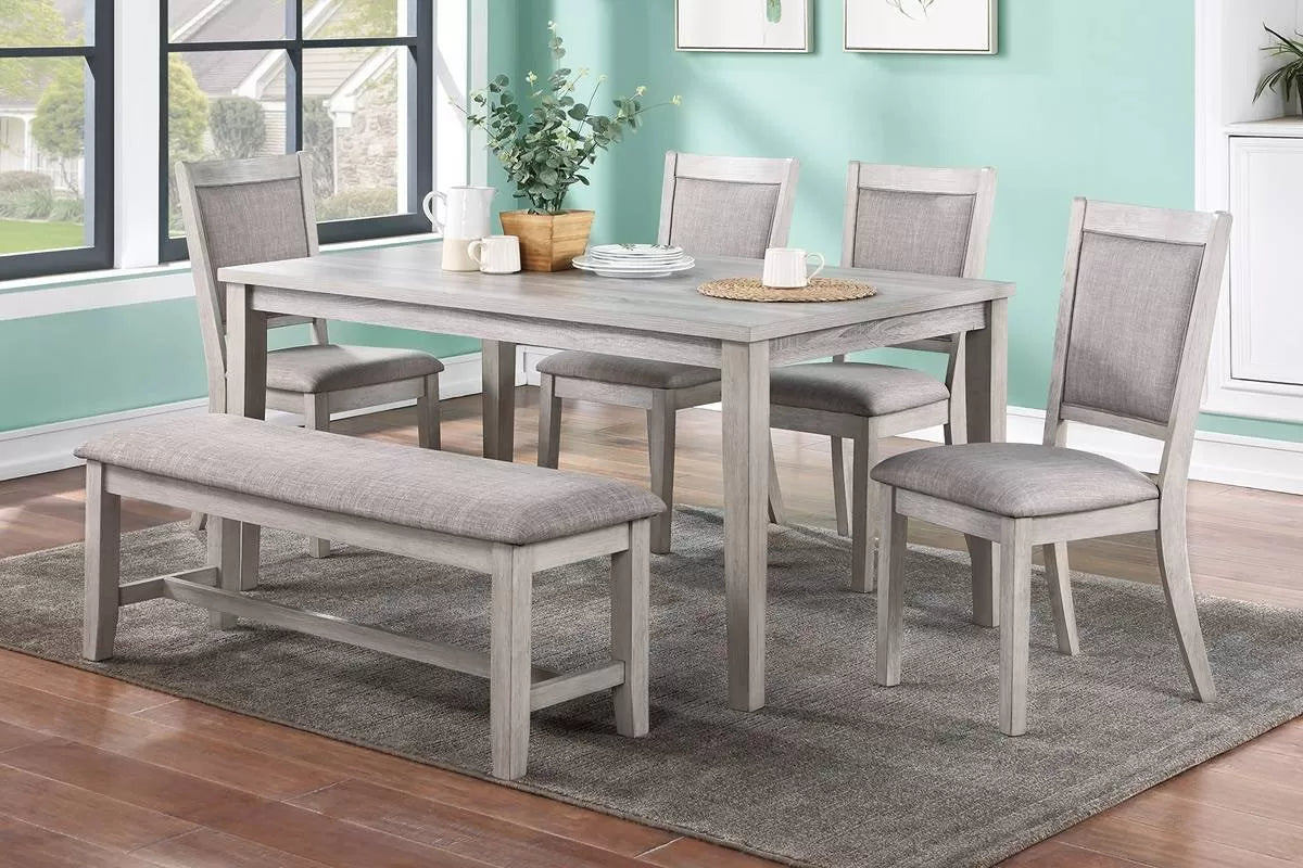 6 Pc light grey dining set with bench and 4 upholstered chairs in a dining room