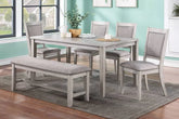 6 Pc light grey dining set with bench and 4 upholstered chairs in a dining room