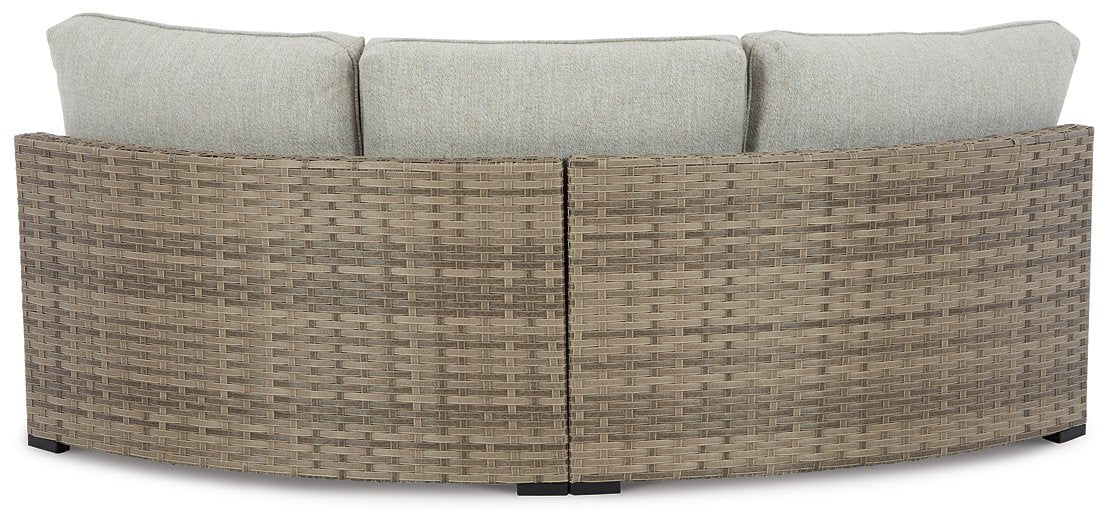 Calworth Outdoor Curved Loveseat with Cushion - Half Price Furniture